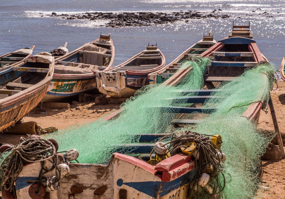 Dakar, Senegal - February 2, 2019: Colored, wooden, fisher  boats on the sandy beach of Dakar,   Africa